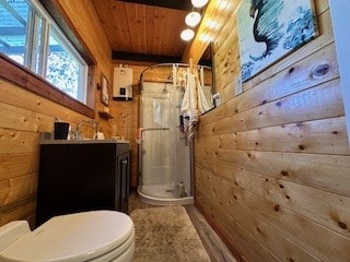 bathroom with a shower with shower curtain, vanity, wooden walls, wooden ceiling, and toilet