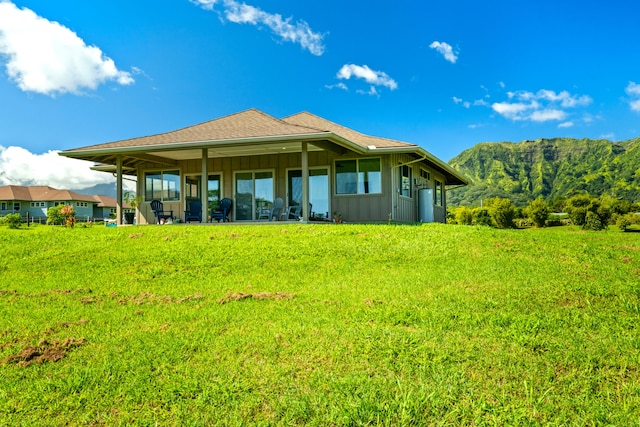 back of property featuring a lawn