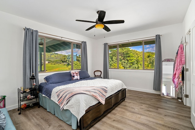 bedroom featuring hardwood / wood-style flooring and ceiling fan