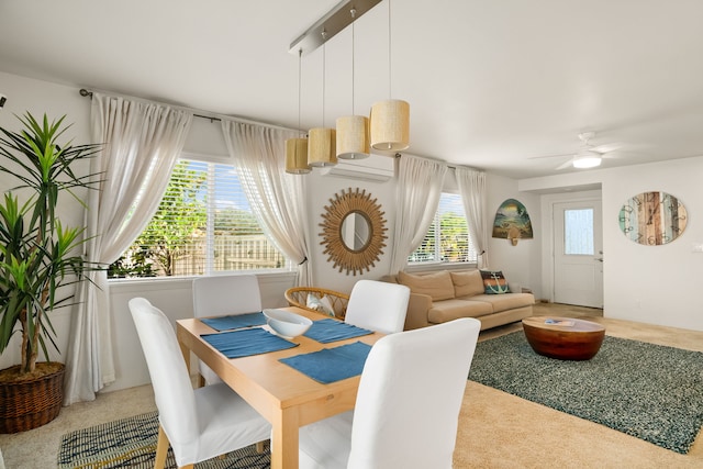 carpeted dining area featuring ceiling fan and plenty of natural light