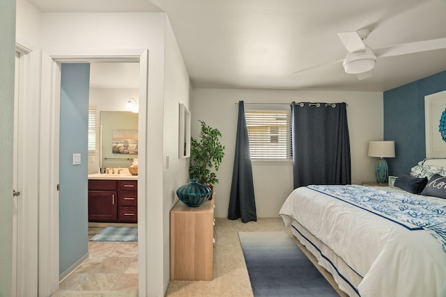 carpeted bedroom featuring ensuite bathroom and ceiling fan