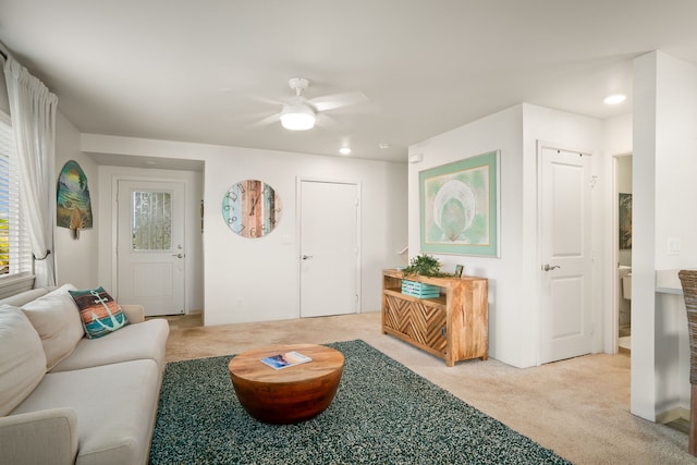 carpeted living room featuring ceiling fan