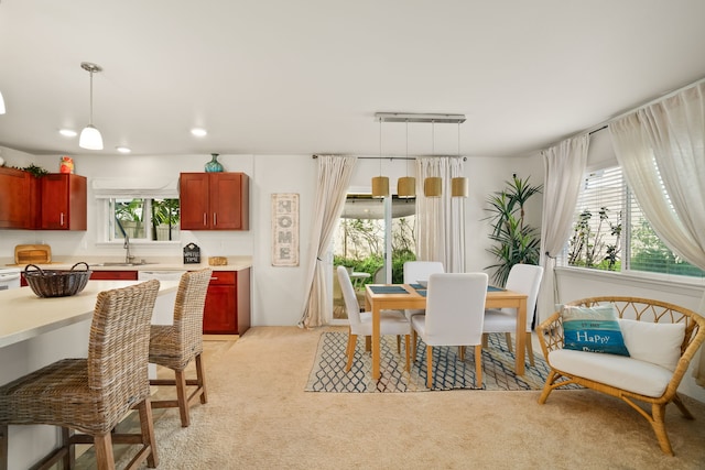 dining area with light colored carpet and sink