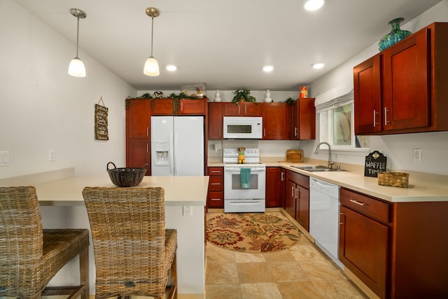 kitchen with pendant lighting, white appliances, and sink