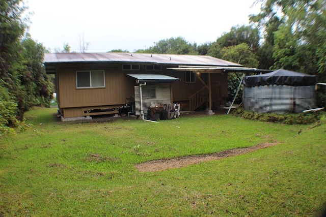 rear view of property featuring a yard