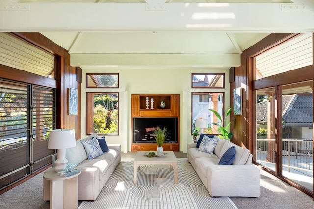 sunroom / solarium featuring lofted ceiling with beams