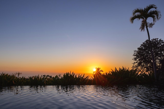 nature at dusk featuring a water view