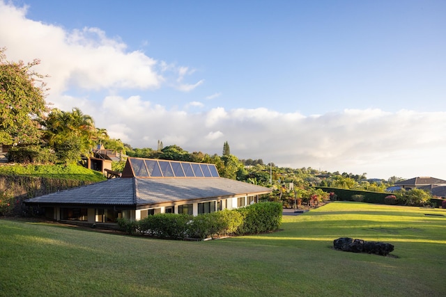 view of side of home featuring a lawn