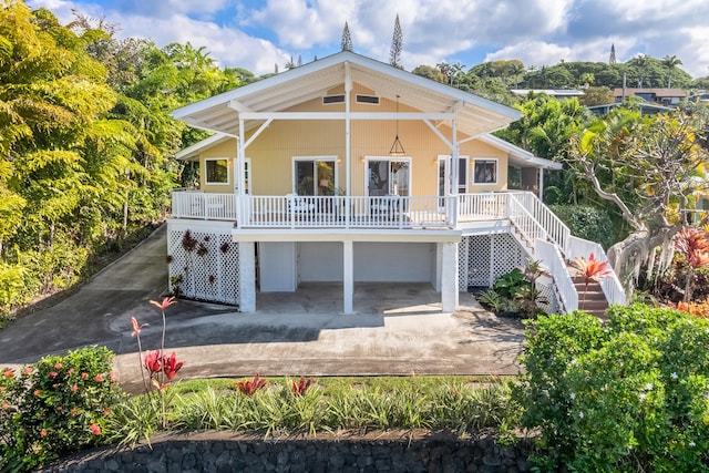 back of property featuring covered porch