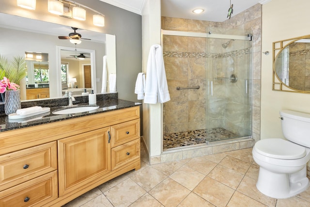 bathroom featuring ceiling fan, toilet, a shower with door, and crown molding