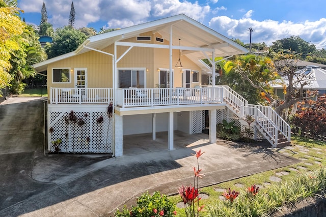 back of property with covered porch and a carport