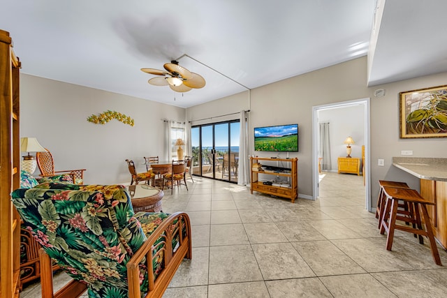 tiled living room featuring ceiling fan