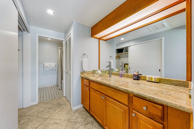 bathroom featuring tile patterned flooring and vanity