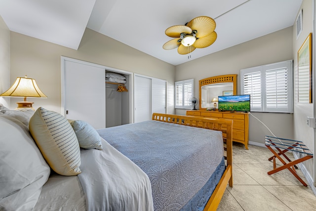 tiled bedroom with ceiling fan and a closet