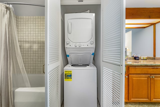 laundry room with stacked washer / dryer