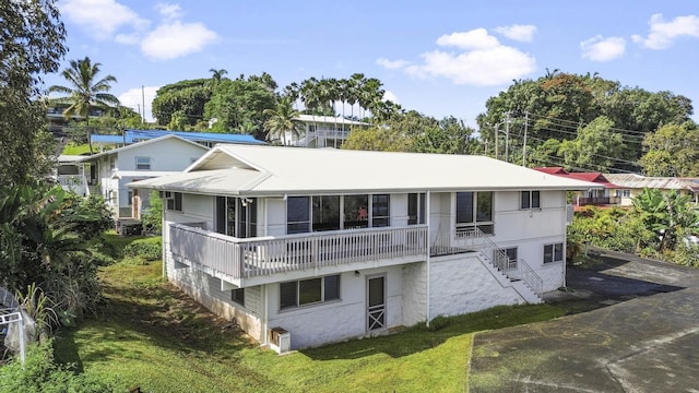 rear view of house with a yard