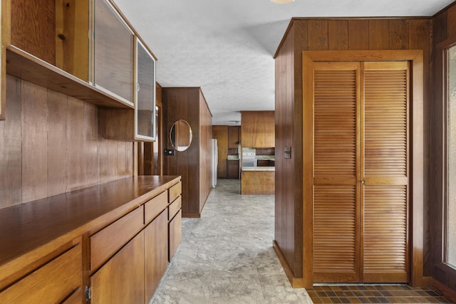 kitchen featuring wood walls