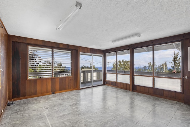 unfurnished sunroom with plenty of natural light