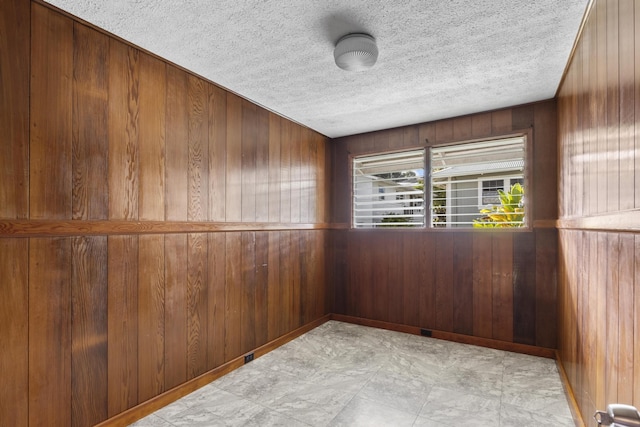 unfurnished room with wood walls