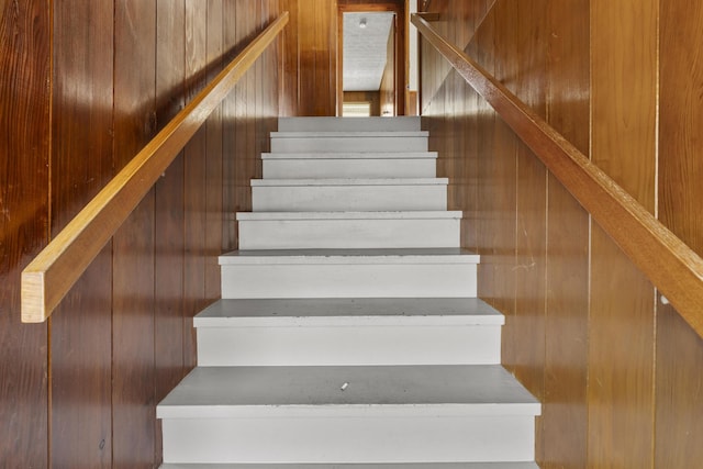 stairway with wood walls