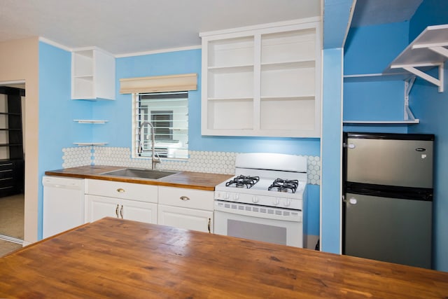 kitchen with wood counters, backsplash, white appliances, sink, and white cabinetry