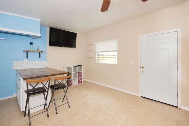 interior space featuring ceiling fan