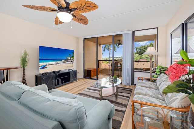 living room with hardwood / wood-style floors and ceiling fan