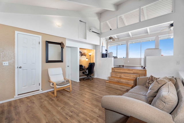 living room with wood-type flooring, a wall unit AC, and ceiling fan