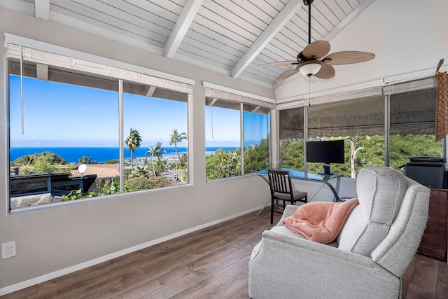 sunroom / solarium featuring ceiling fan, lofted ceiling with beams, and wooden ceiling