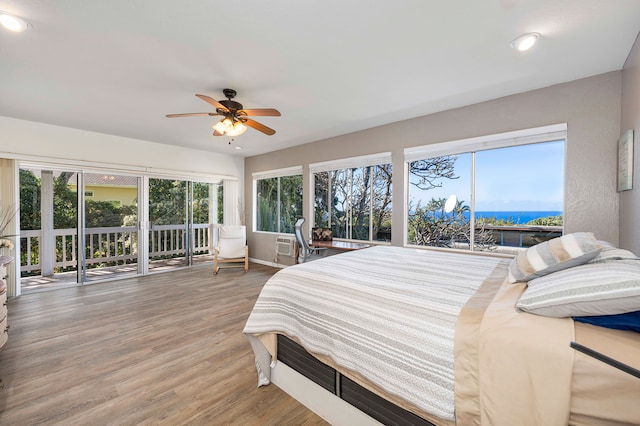 bedroom with access to exterior, wood-type flooring, and ceiling fan