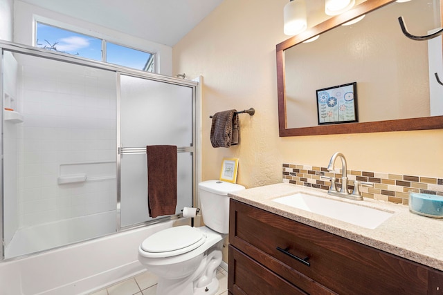 full bathroom with vanity, tile patterned floors, decorative backsplash, toilet, and enclosed tub / shower combo