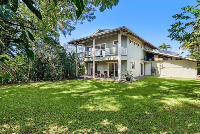 back of property featuring a lawn and a patio area