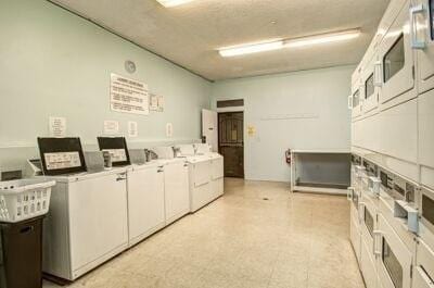 laundry room featuring separate washer and dryer and stacked washer and dryer