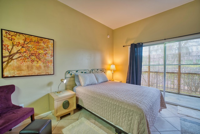 bedroom featuring light tile patterned flooring, access to outside, and vaulted ceiling