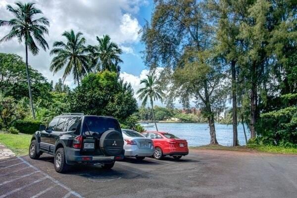 view of car parking with a water view