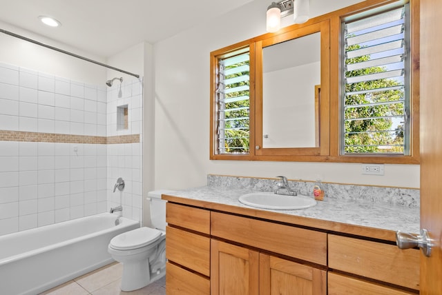 full bathroom featuring tile patterned floors, vanity, toilet, and a wealth of natural light