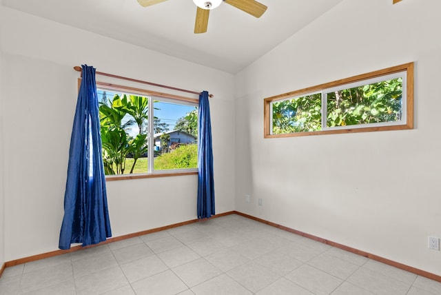 tiled spare room featuring ceiling fan and vaulted ceiling