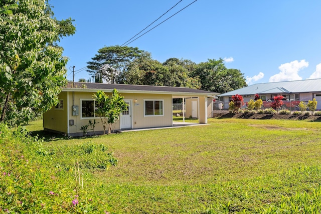 rear view of house with a lawn