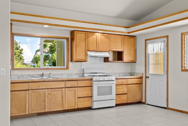 kitchen with white gas range, sink, vaulted ceiling, decorative backsplash, and light tile patterned floors