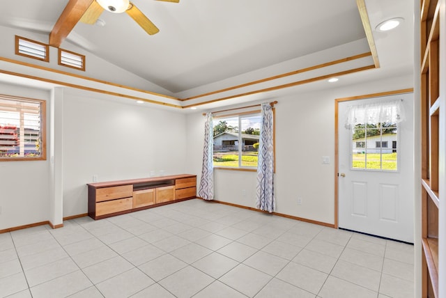 tiled spare room with lofted ceiling with beams, ceiling fan, and a healthy amount of sunlight