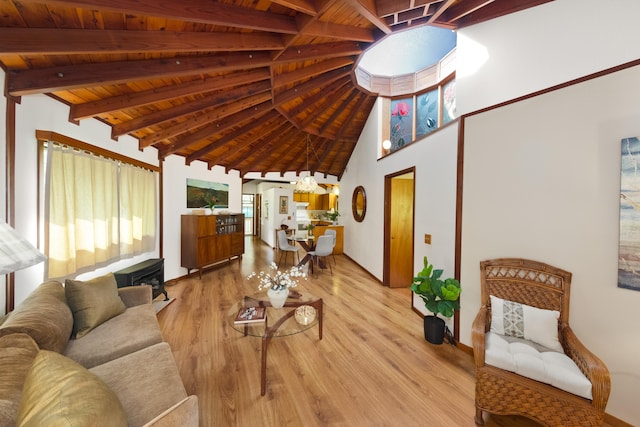 living room with high vaulted ceiling, light hardwood / wood-style flooring, beam ceiling, and wood ceiling