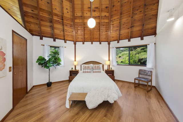 bedroom featuring wood ceiling, light wood-type flooring, beam ceiling, and multiple windows