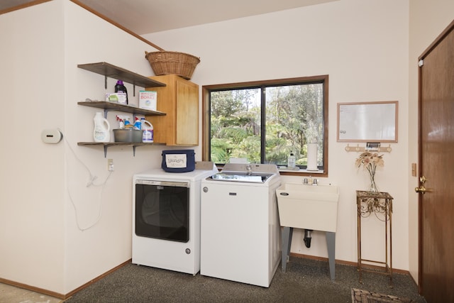 washroom featuring cabinets and separate washer and dryer