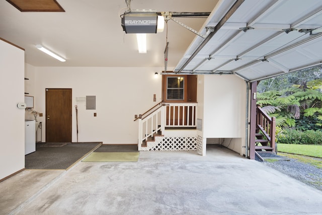 garage with a garage door opener and electric panel