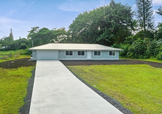 view of front of house featuring a garage and a front lawn