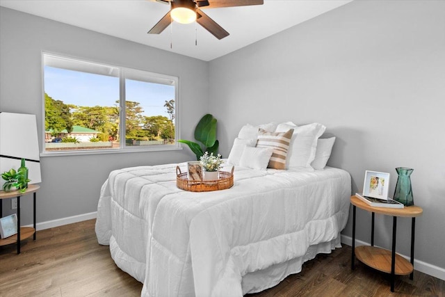 bedroom with ceiling fan and dark wood-type flooring