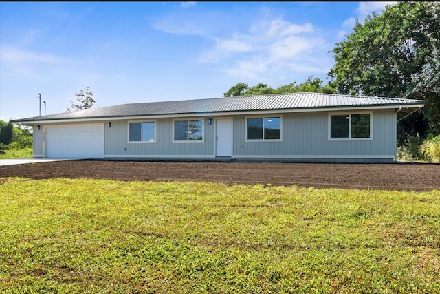 ranch-style home with a garage and a front lawn