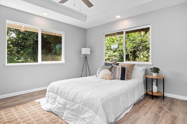 bedroom with ceiling fan and hardwood / wood-style floors