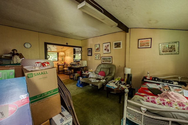 interior space featuring carpet flooring, lofted ceiling with beams, wood walls, and a textured ceiling