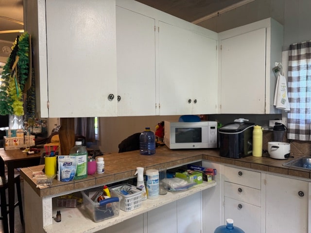 kitchen featuring white cabinets